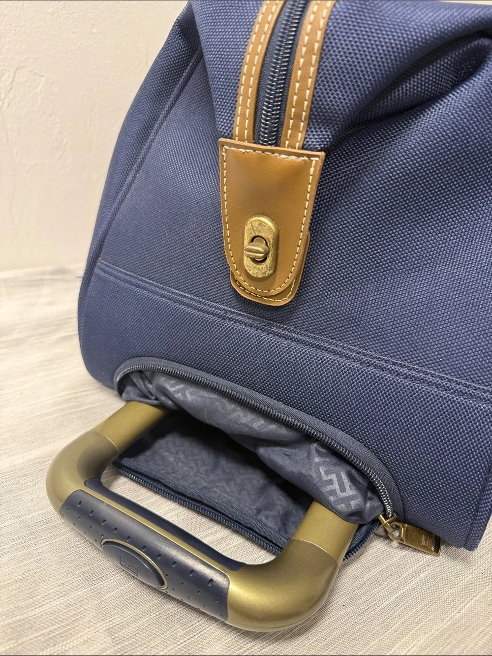 Tommy Hilfiger Navy rolling Duffel with Red & White Center Stripe  carry on